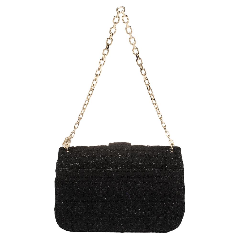 Flap bags like this Miss Dior will never go out of style. Crafted from tweed, this Dior bag features a black Cannage exterior and a chain strap. The front flap has a gold-tone lock that opens to a leather-lined interior with enough space to keep