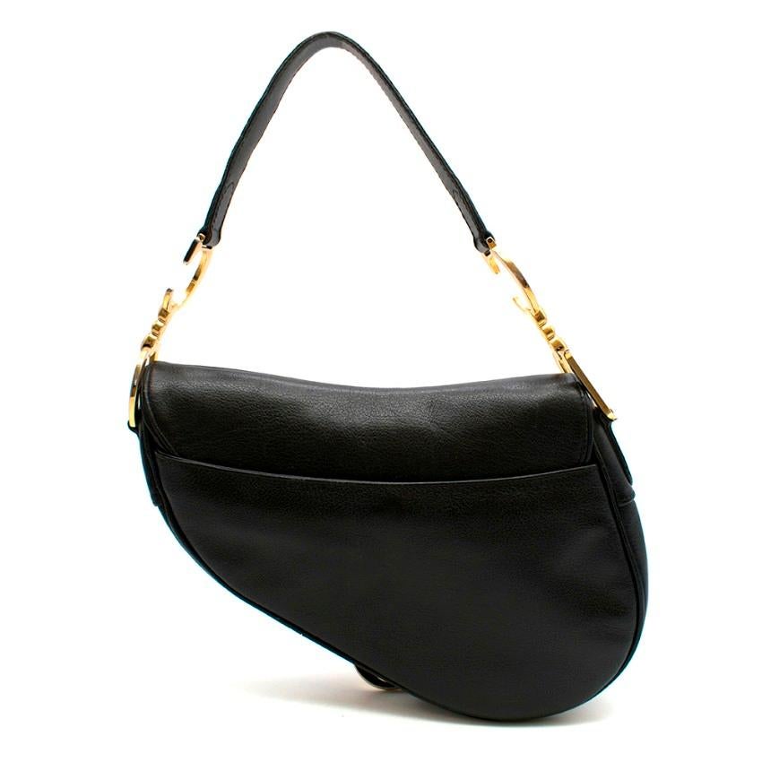 Dior Black Vintage Leather Saddle Bag 

- 'D' stirrup with velcro closure
- 'CD' signature on handle
- Antique gold-finish metal
Back pocket
- Interior zip pocket
- May be carried by hand or over the shoulder
- Dust bag included

Material
- Calf