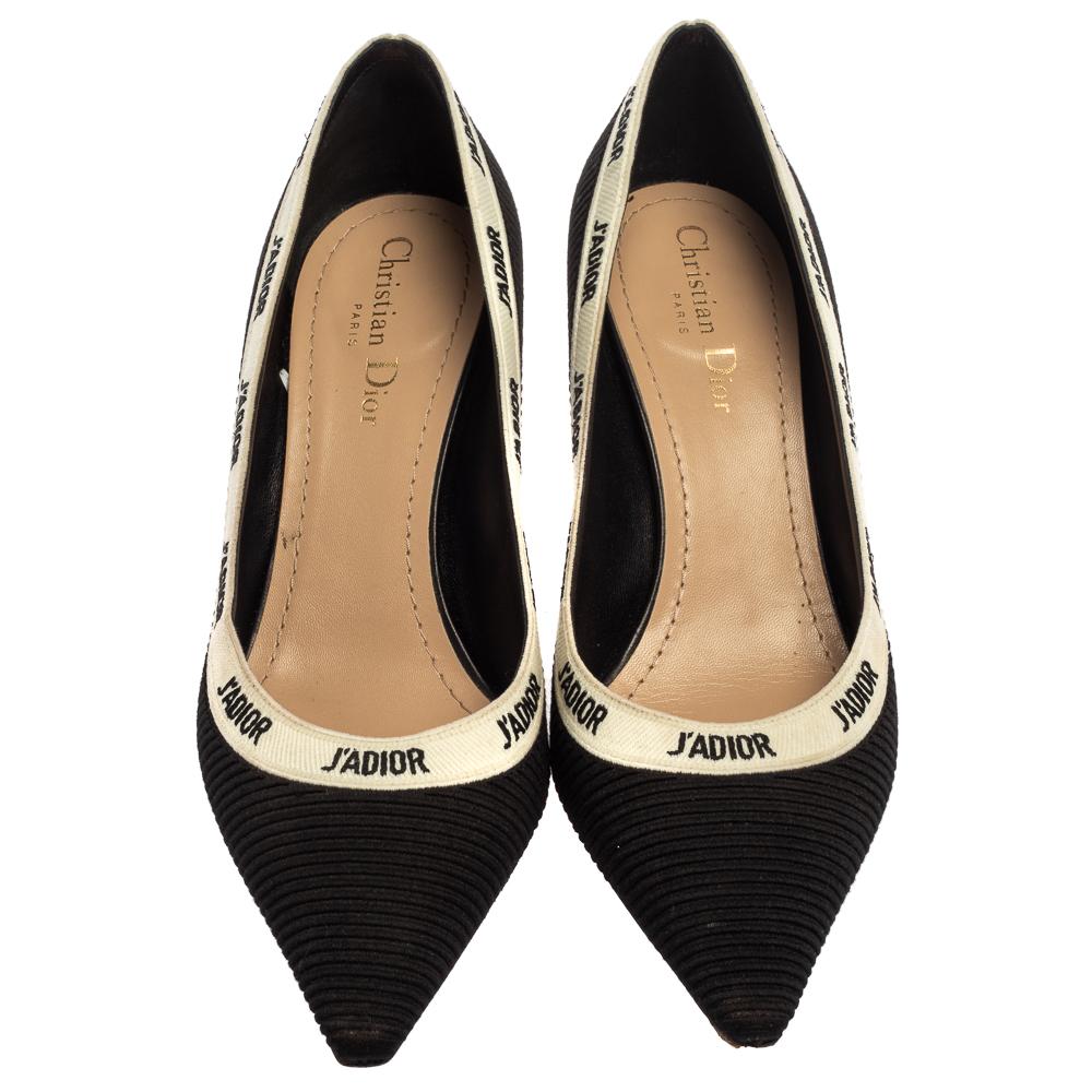 These popular J'Adior pumps exude an elegant and sophisticated aesthetic. Crafted from fabric in a black shade, the sandals have a sleek design with pointed toes. Adorned with white ribbons featuring the iconic 'J'Adior' wording and kitten heels,