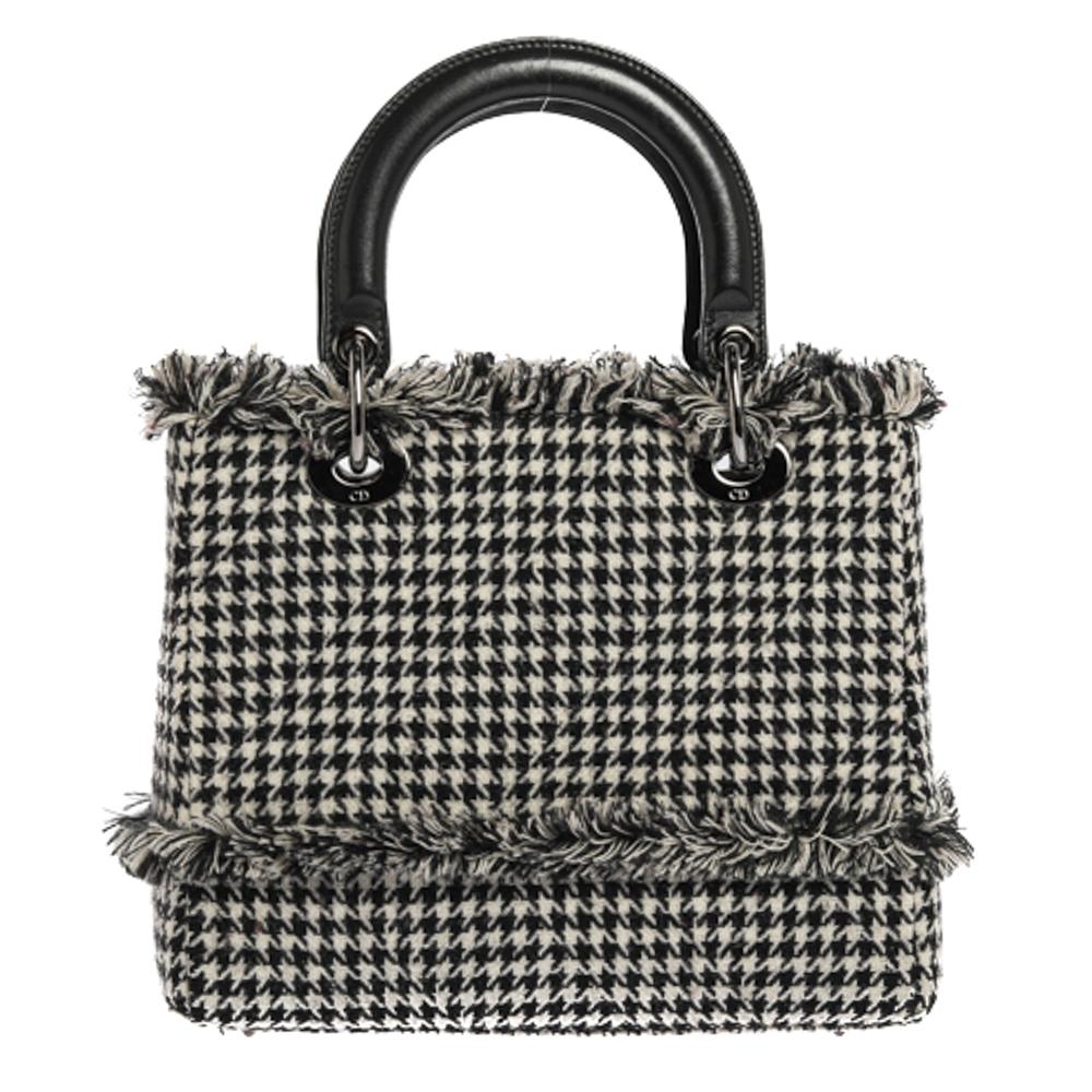 The Lady Dior tote is a Dior creation that has gained recognition worldwide and is today a coveted bag that every fashionista craves to possess. This black & white tote has been crafted from tweed fabric and it carries a houndstooth pattern. It is