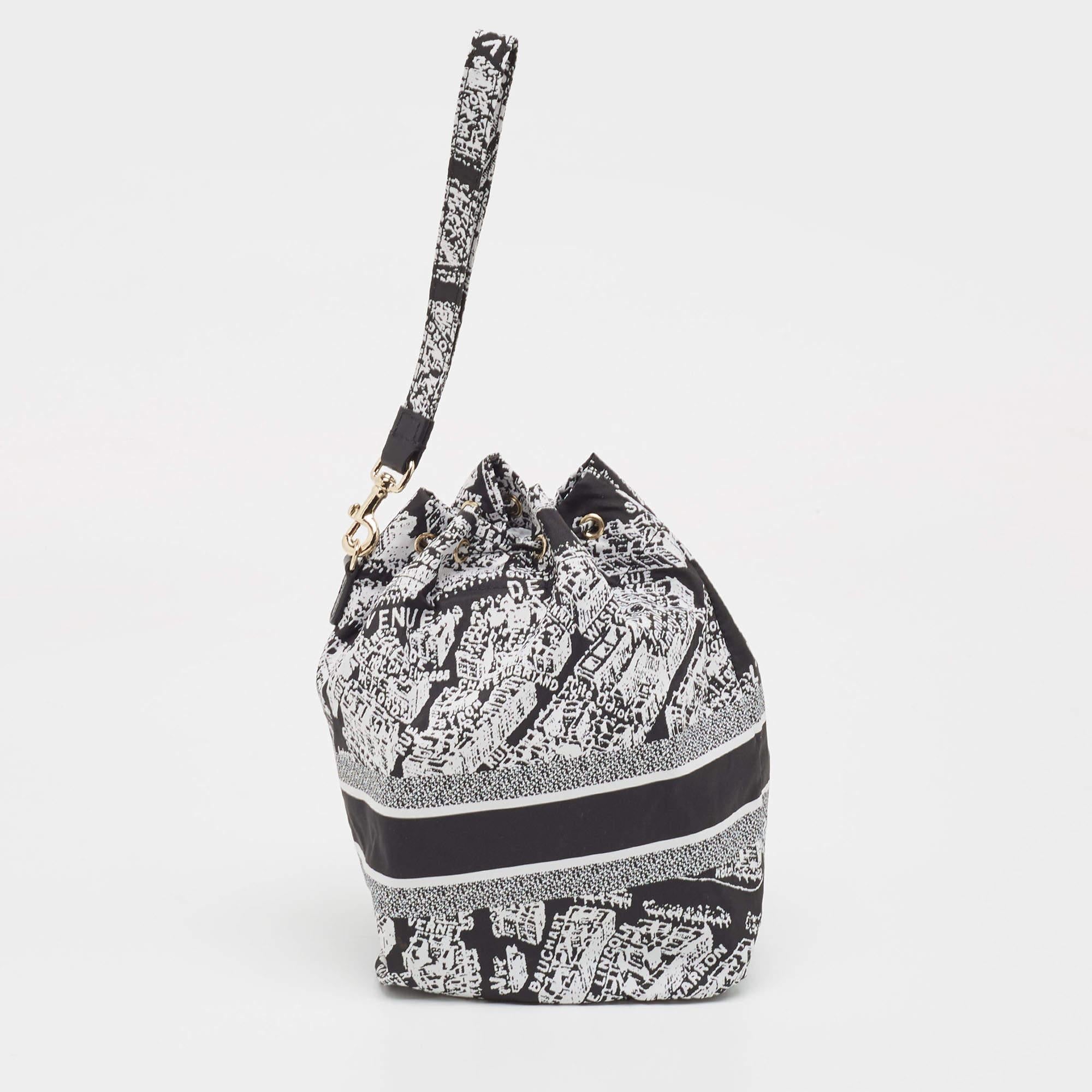 The Dior Diortravel Pouch is a chic and compact accessory featuring the Plan De Paris motif. Crafted from durable nylon, it boasts a black and white color scheme, exemplifying sophisticated Parisian style. Ideal for organizing essentials with a
