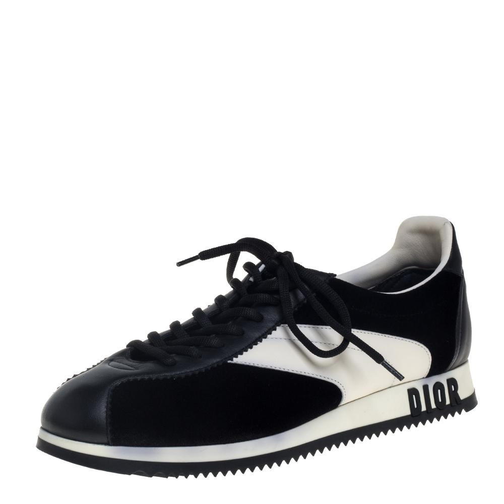 Make a statement everywhere you go by donning these stunning Diorun sneakers by Dior. Crafted in Italy, they are made of quality leather and velvet and come in a classic combination of black and white. They are styled with delicate scalloped