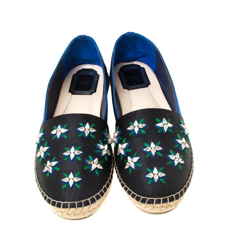 Continue to be your fashionable self even in your casuals by owning these Riviera espadrilles from Dior. They've been crafted from blue/back fabric and styled with crystal embellishments on the vamps and braided details on the midsole. The pair is
