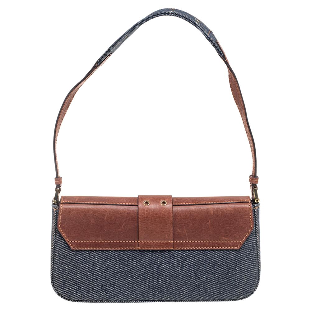 Add the right accessory to your look with this Street Chic shoulder bag from Dior. It comes crafted with leather and denim. It features a front flap attached to which is a belt strap carrying a logo plaque. The frontal flap opens to a fabric-lined