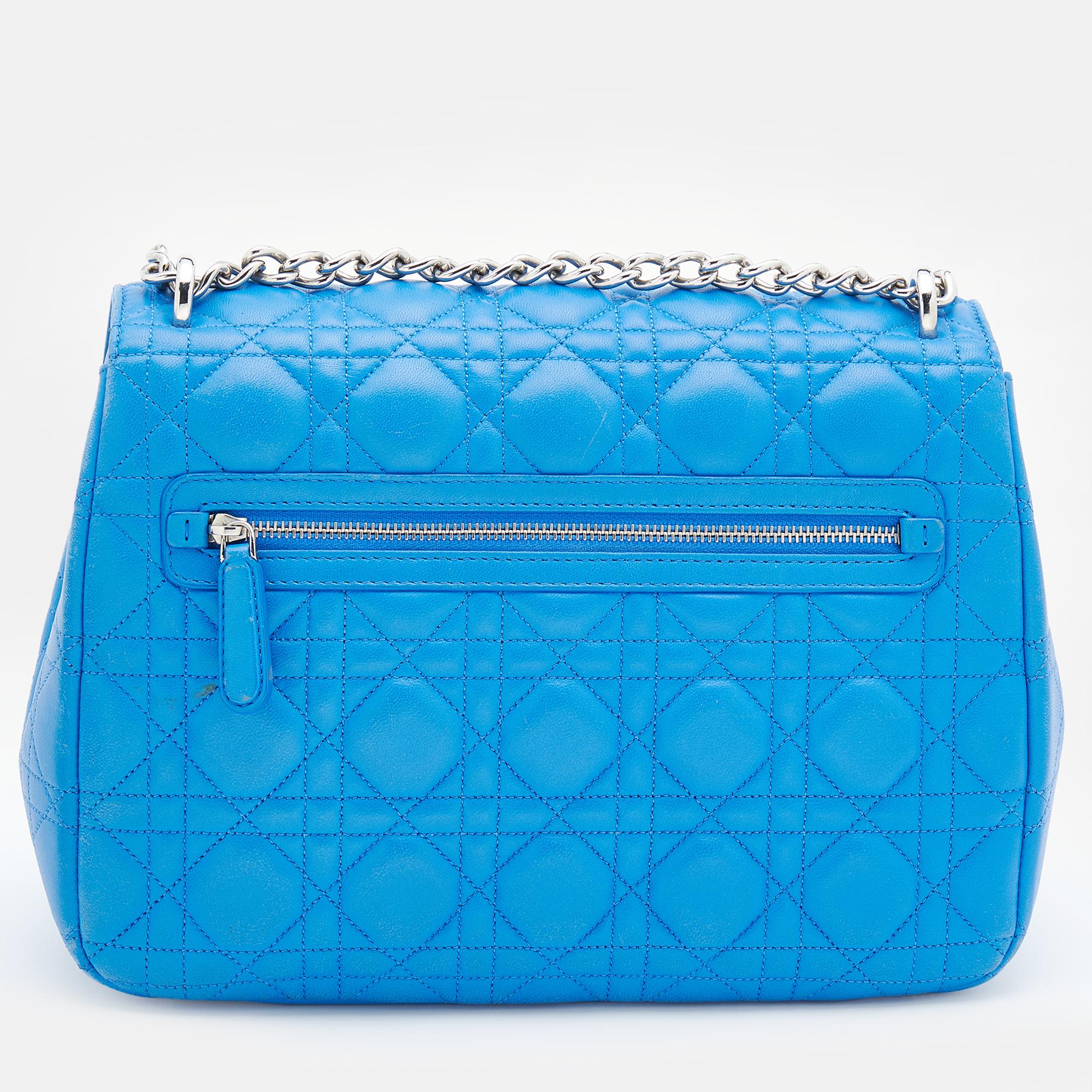 Flap bags like this Miss Dior hold the promise of enduring style to be part of your forever collection. Crafted from leather, this Dior bag features a blue Cannage quilted exterior and a chain-link strap. The front flap has a gold-tone lock that