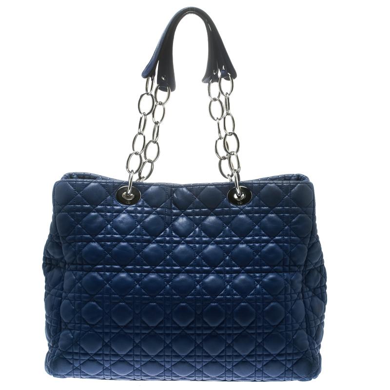 This shopper tote from Dior is a timeless piece. The bag is crafted from luxurious blue quilted leather and has the cannage pattern. It features double top handles, protective feet at the bottom and Dior letter charm in silver tone. A buttoned