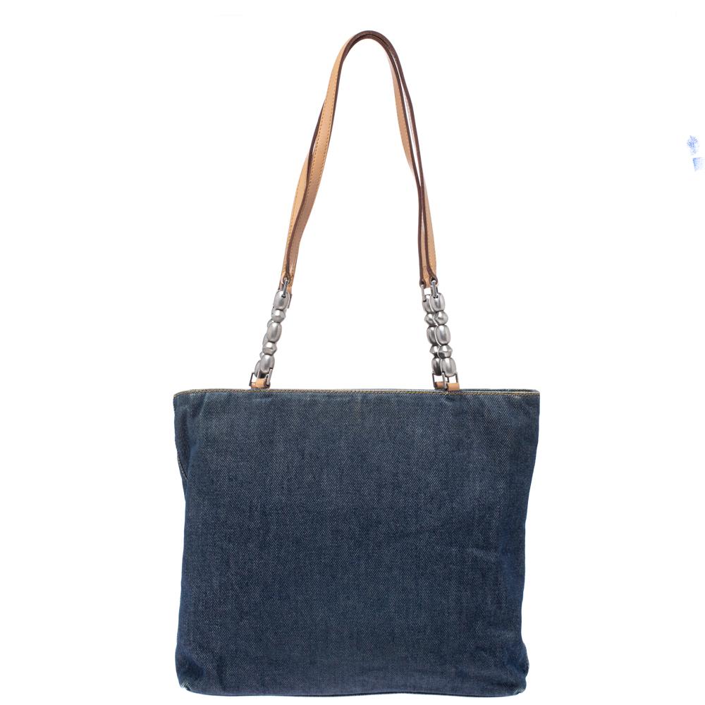 This Maris Pearl tote from Dior is a true blend of luxury and style! It is made of denim as well as leather and features dual handles and an engraved detail on the front. It has a capacious nylon-lined interior that can easily fit in all your daily