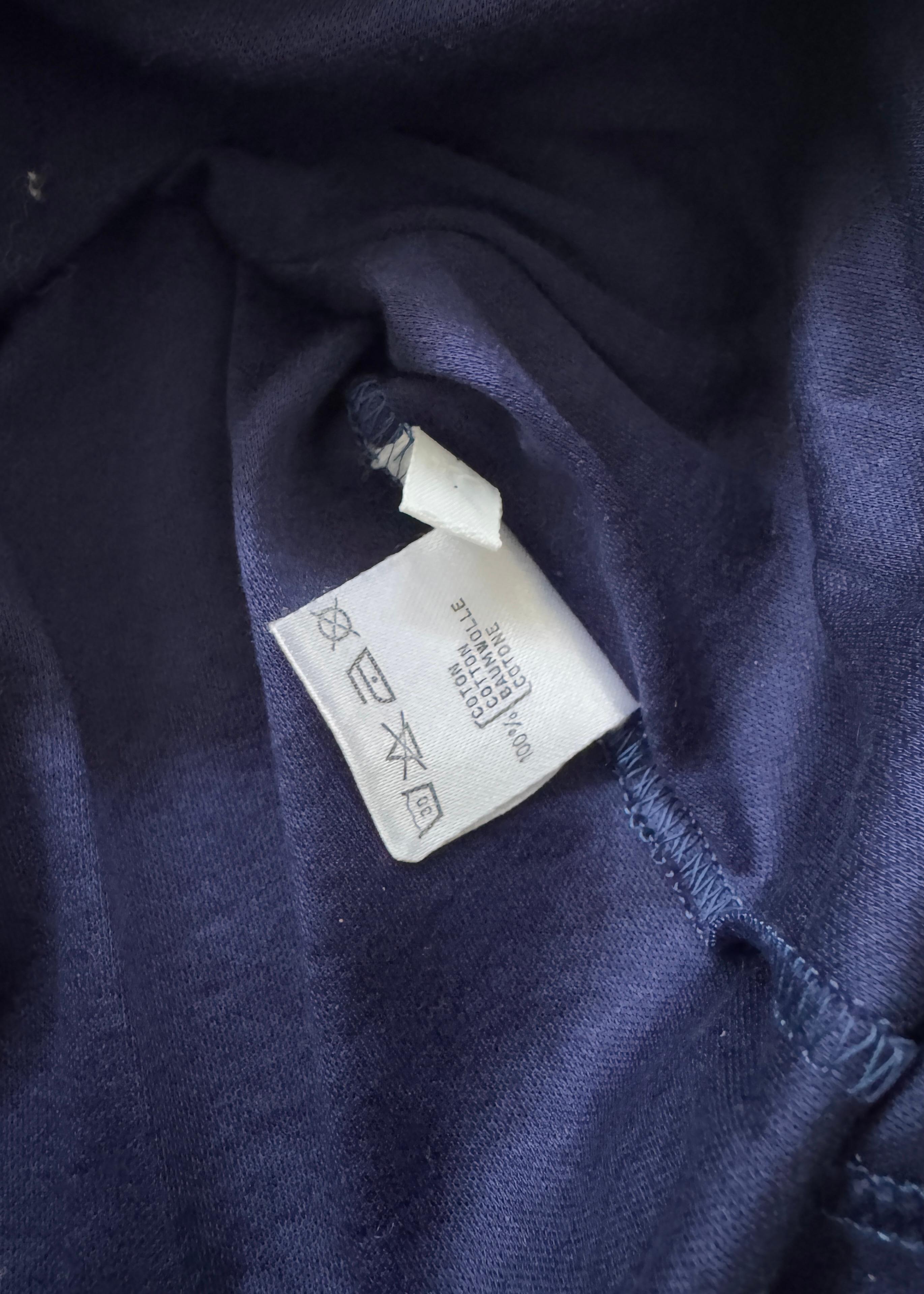 This rare vintage Dior T-shirt captures the playful yet refined spirit of early 2000s fashion. Made from a soft, lightweight cotton-blend jersey in a rich blue hue, it features a slightly fitted silhouette and short sleeves that flatter the form
