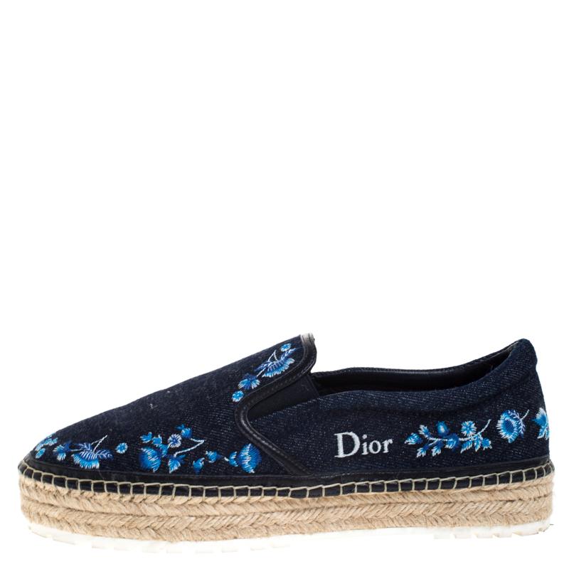 Continue to be your fashionable self even in your casuals by owning these espadrille loafers from Dior. They've been crafted from blue denim featuring leather trims. They are styled with little embroidered florals and braided details on the midsole.