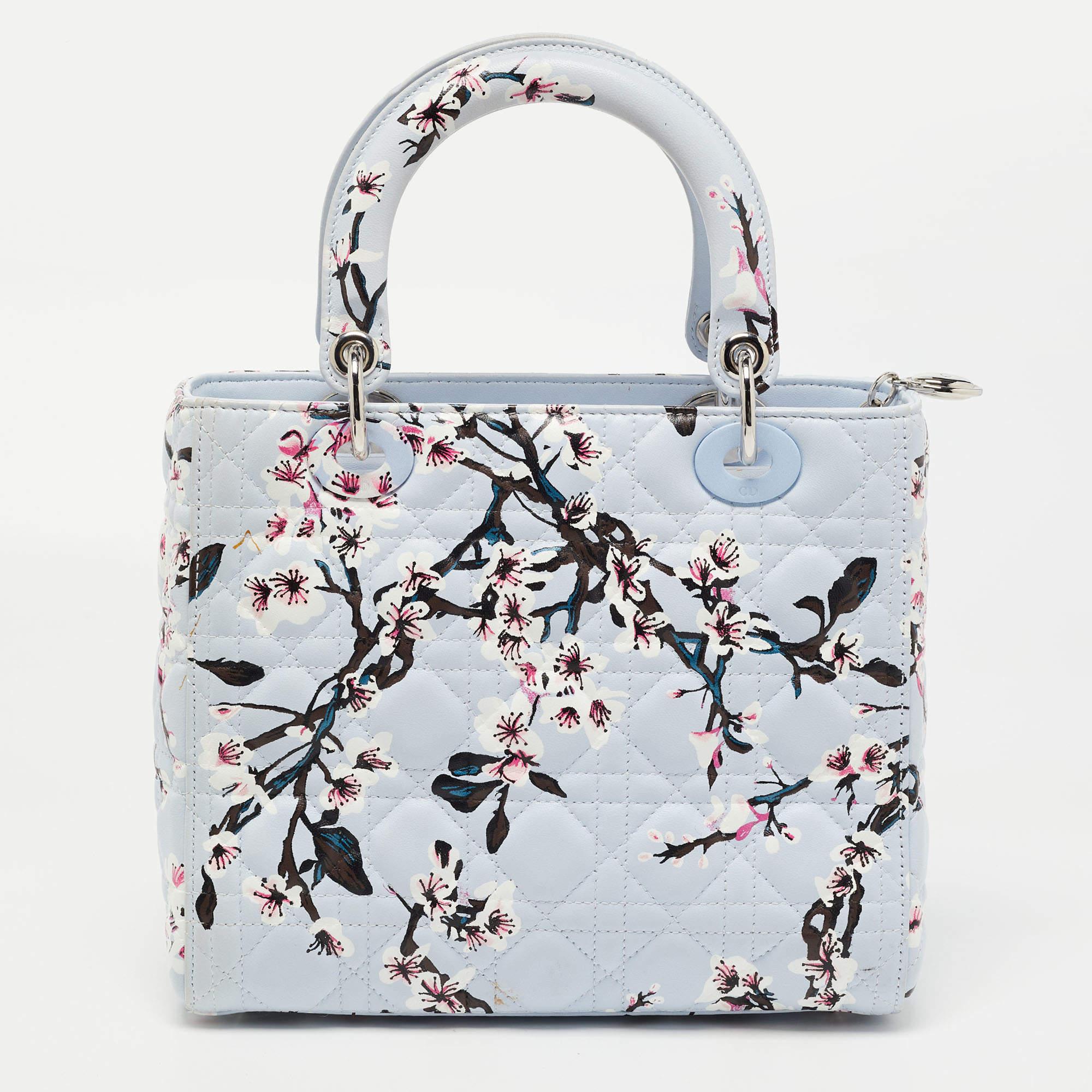 The magical spell of blooming flowers surrounds this special version of the Lady Dior tote. The delicate round handles, the always-handy detachable strap, the magnetic Cannage quilt, and the soothing blue hue power the iconic silhouette into