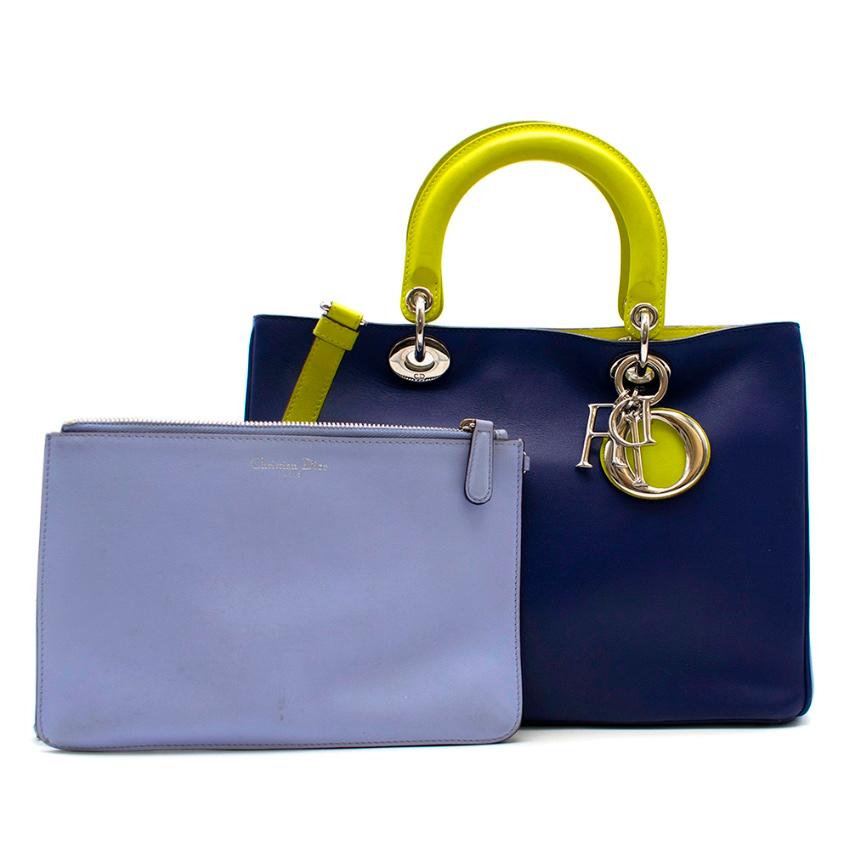 DIor Blue & Green Satin Finish Diorissimo Tote Bag

- Silver-tone jewellery
- Magnetic closure 
- Light blue clutch bag included
- Two lining inner pockets
- Carry in the hand or on the shoulder

Please note, these items are pre-owned and may show