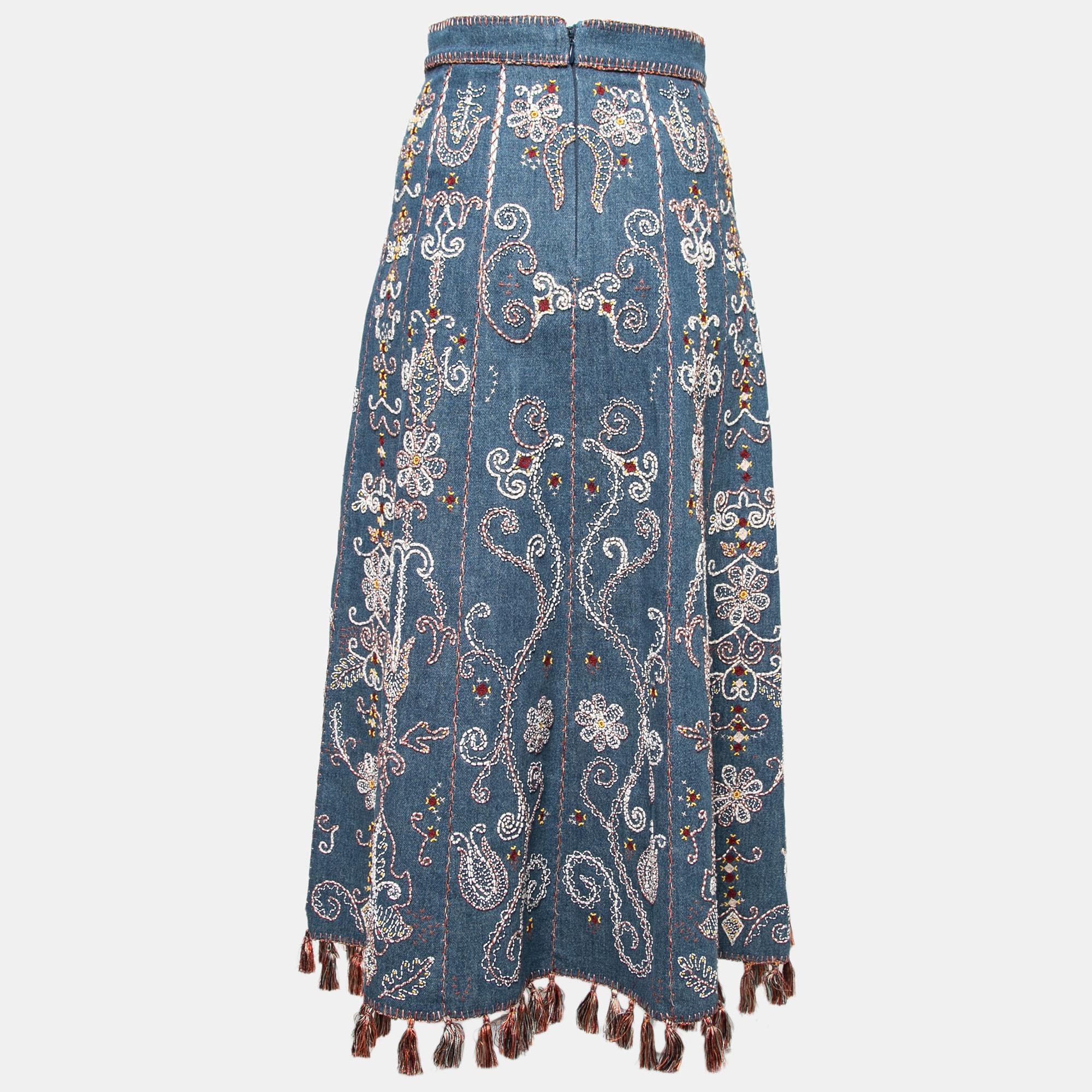 Exude a boho-chic vibe whenever you wear this skirt from the House of Dior. Augmented with beautiful hand embroidery and tassel trims, this skirt is cut from blue denim fabric and equipped with a zipper for fastening. Complement this Dior skirt with