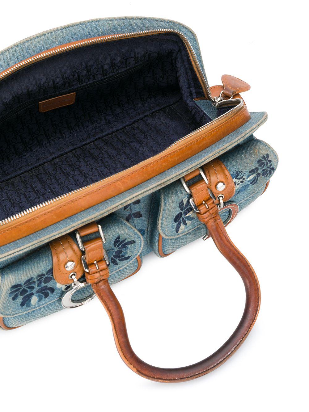 2006s Christian Dior blue jean embroidered floral handbag featuring camel leather trim, two rounded top handles, top zip fastening, floral embroideries, logo charm, front pockets, Monogram lining.
Width 11.8in. (30cm) 
Height 5.5in. (14cm)
Depth