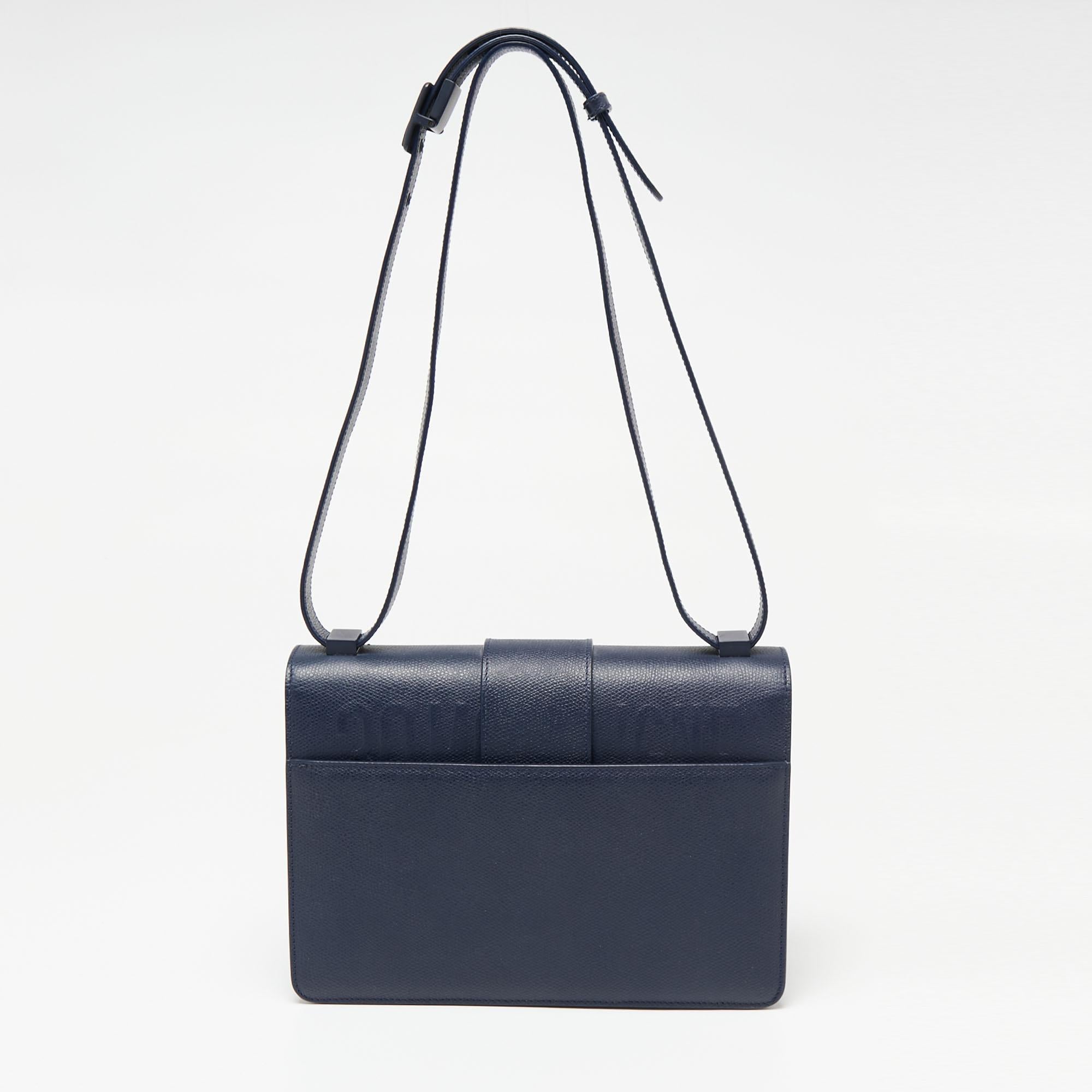 A fine collaboration of historical inspiration, artisanal savoir-faire, and signature brand aesthetic, this 30 Montaigne bag from Dior is a creation brimming with excellence and allure. This version displays a blue leather exterior with a tonal CD