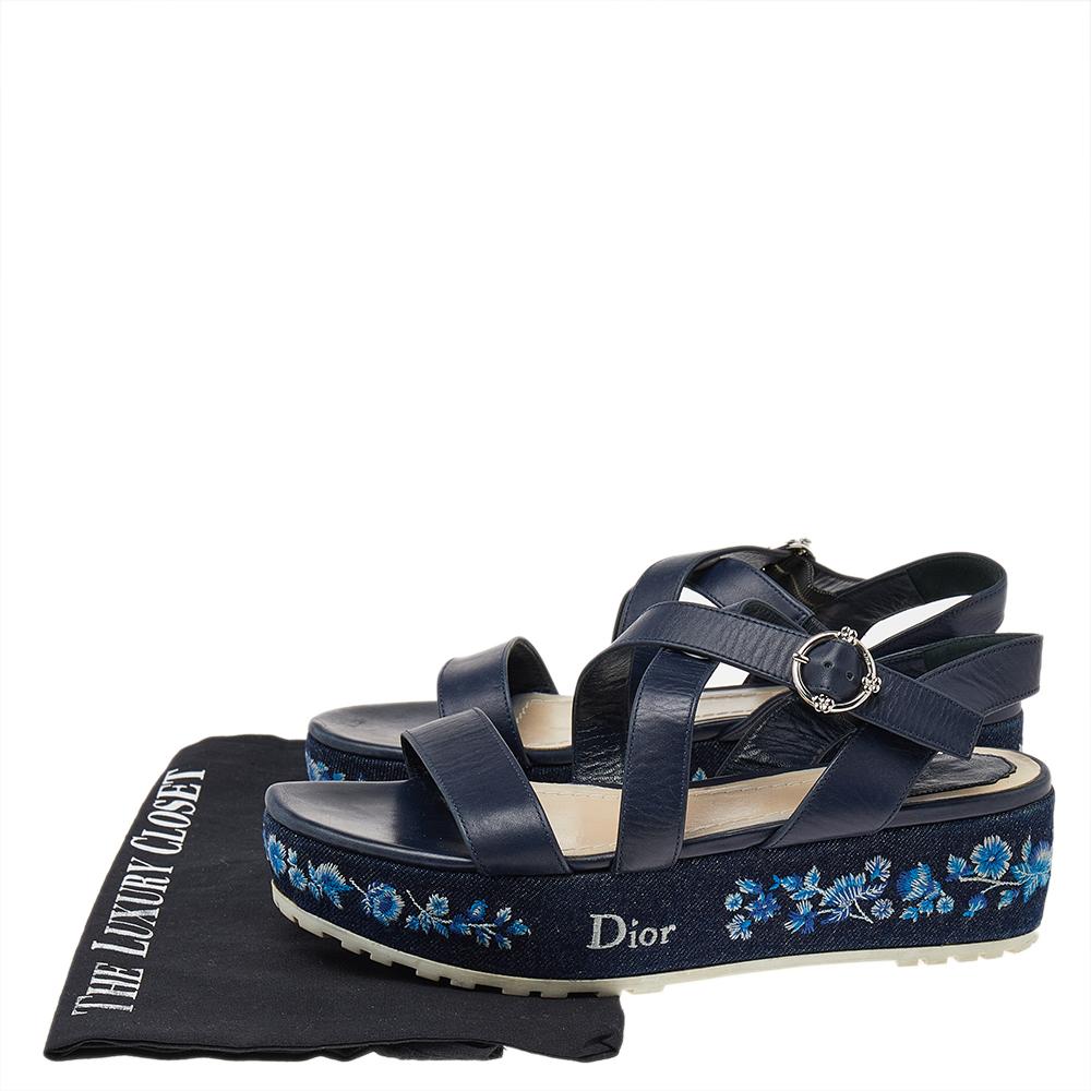 The fine artistry and the feminine silhouette of these sandals exhibit Dior's years of impeccable craftsmanship. Crafted from leather in a blue shade, they feature crisscrossed straps, neat embroidery, and have comfortable soles. The sandals are