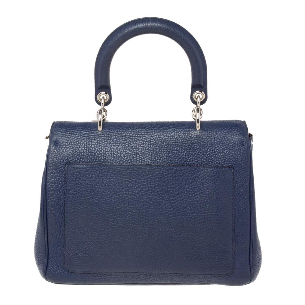 This Be Dior bag from the House of Dior is sure to add sparks of luxury to your wardrobe! It is crafted using blue leather on the exterior, with the signature D.I.O.R charms embellishing the front. It has a top handle, silver-toned hardware, and an