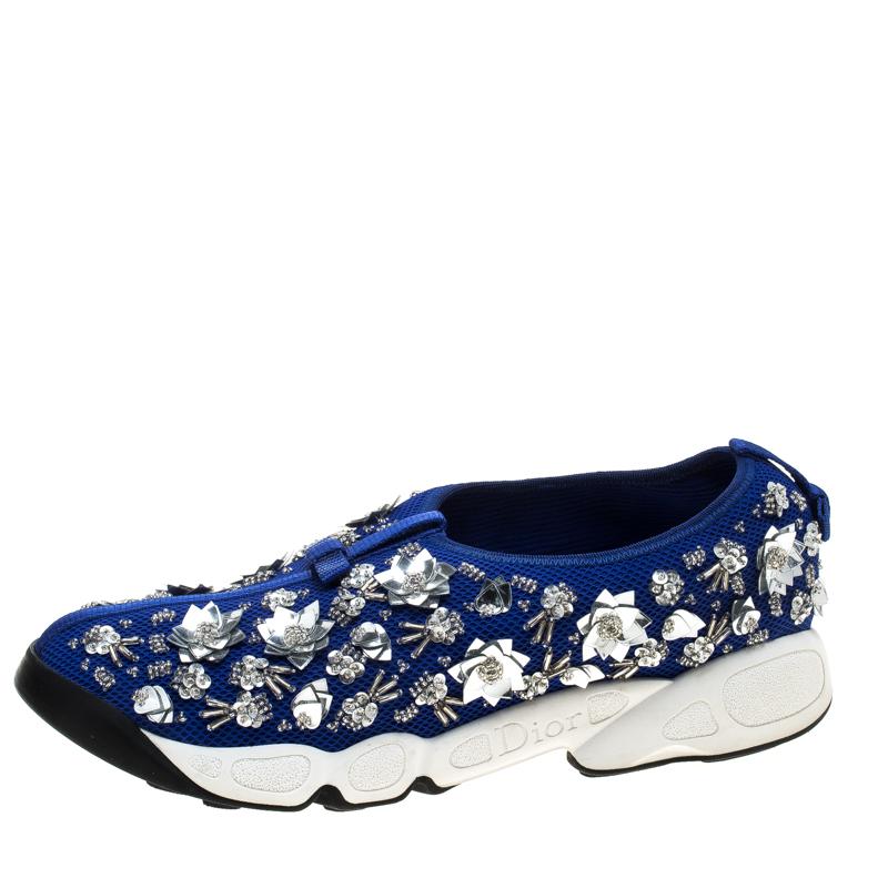 These Dior Fusion slip-on sneakers styled with a blue mesh exterior will keep you comfortable with a feminine glam style. Featuring beautiful floral embellishments all through the surface, these shoes are complete with rubber soles that are detailed