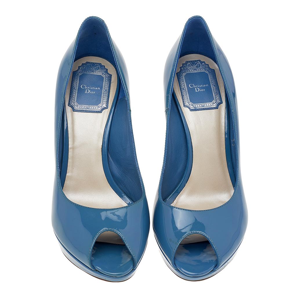 The Miss Dior collection from Dior is a significant creation that continues to attract everyone with its impeccable style. These Miss Dior pumps are created from blue patent leather and feature peep-toes, platforms, and high heels. Step out boldly