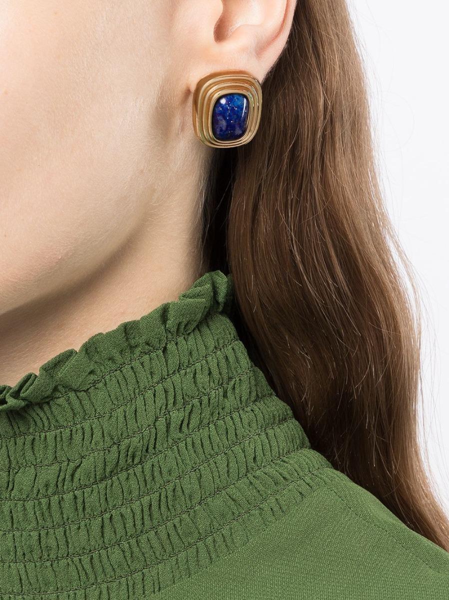 These timeless 1980s pre-owned Christian Dior earrings have been crafted from gold plated metal and feature a central blue cabochon stone. Designed with a clip-on closure to ensure comfort for all-day wear, these earrings can add a touch of colour