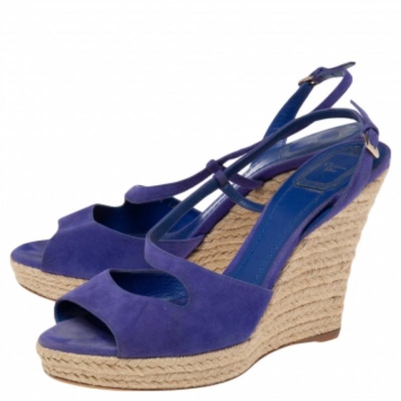 Gleaming with beauty, this pair of wedge sandals by Dior has only the finest details. They've been wonderfully styled with blue-hued suede straps and elevated on espadrille wedges. Complete with buckle straps and leather insoles, this pair is a