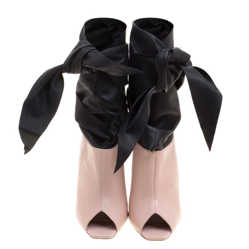 Well, isn't this Dior pair simply stunning! They've been designed so beautifully with leather that they make one's heart flutter. The ankle boots come in a mix of blush pink and black, with peep toes, finely sculpted 11.5 cm heels and a wrap style