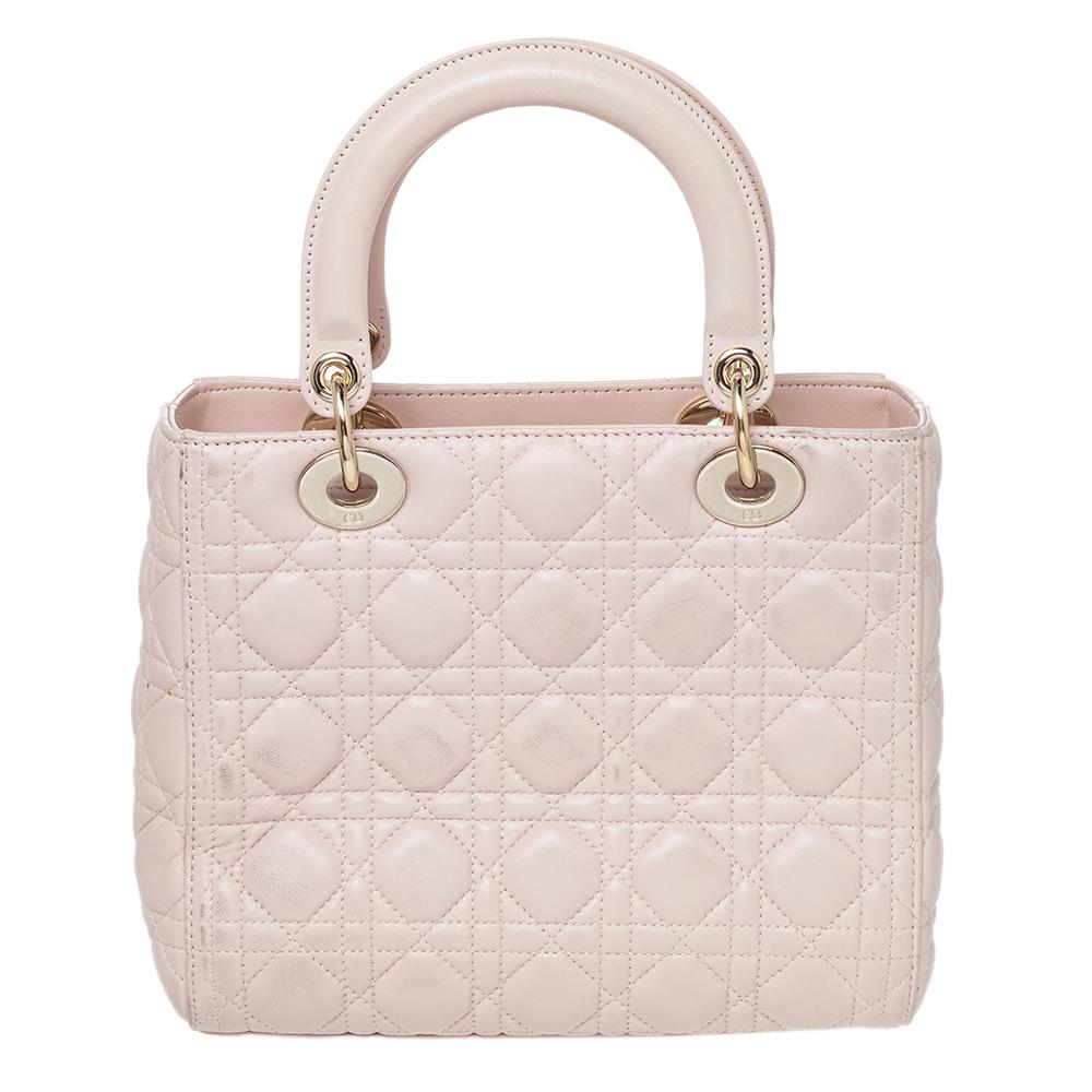 The Lady Dior tote is a Dior creation that has gained recognition worldwide and is today a coveted bag that every fashionista craves to possess. This blush pink tote has been crafted from leather and it carries the signature Cannage quilt. It is