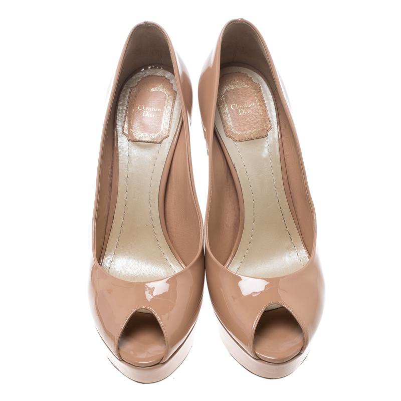Dior has always been known to churn out uniquely designed pumps just like this one. Add a splash of elegant charm to your ensemble with this pink pair. They are rendered in patent leather and feature peep toes with 13.5 cm heels that are accented