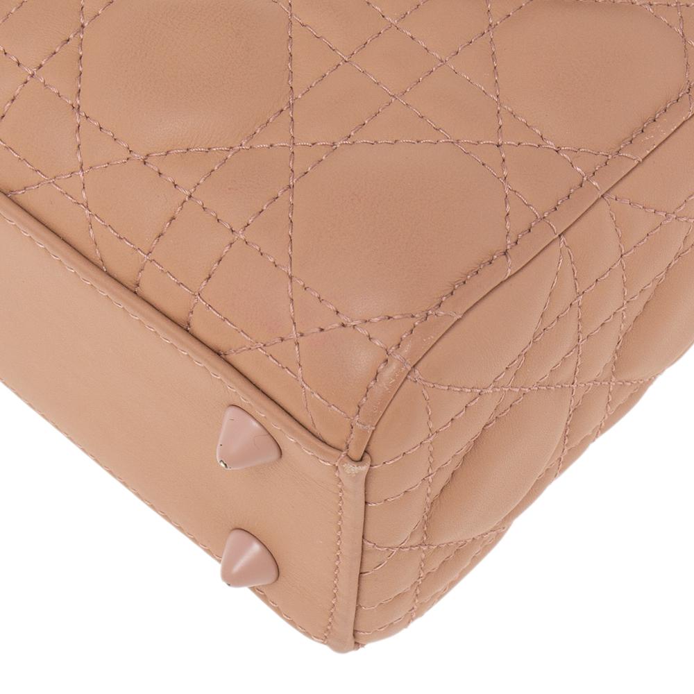 A timeless status and great design mark the Lady Dior tote. It is an iconic bag that people continue to invest in to this day. We have here this Small My Lady Dior tote crafted from blush ultra-matte Cannage leather. The bag is complete with two top