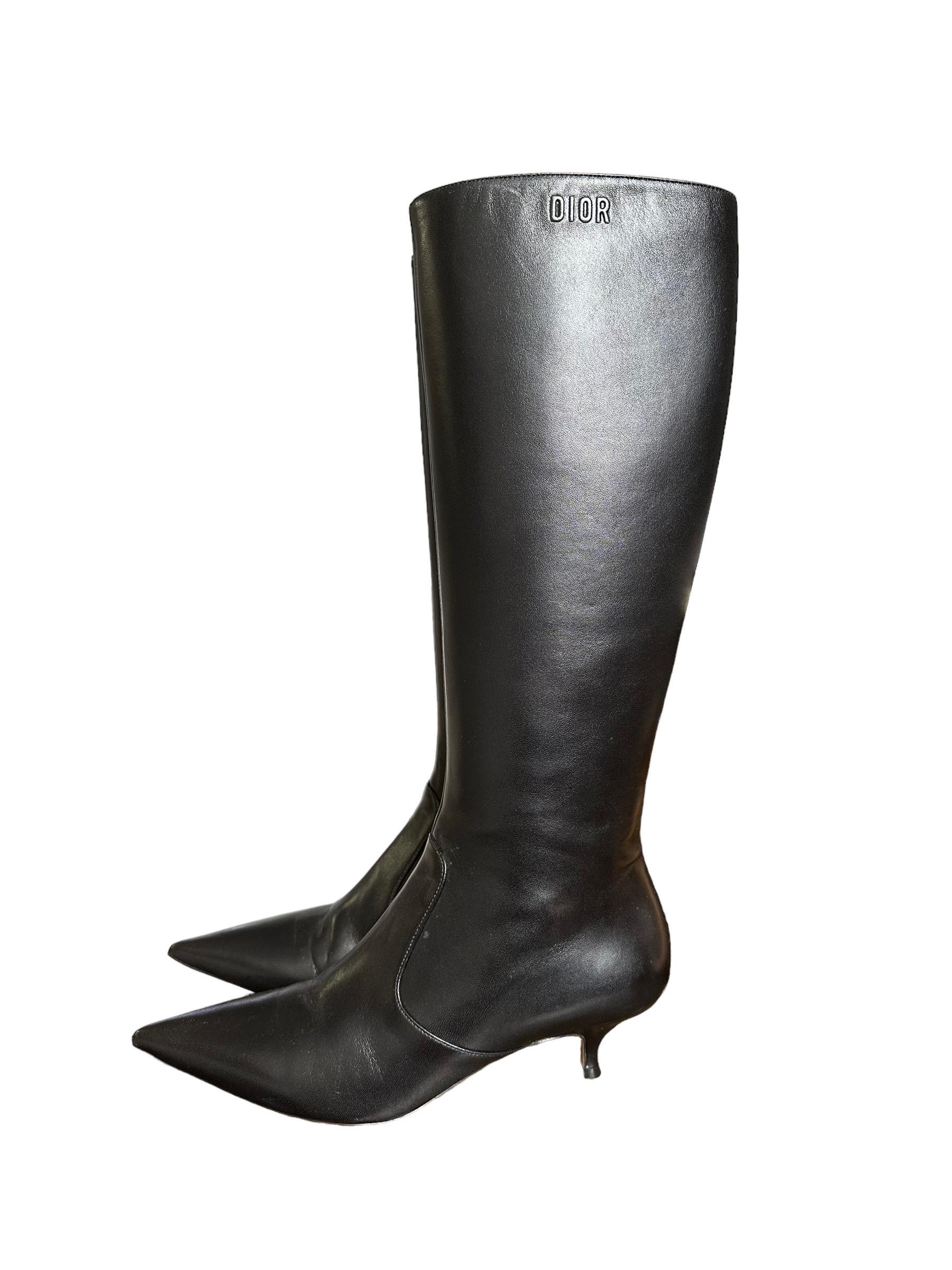 Dior designer boots, made in black smooth leather with silver hardware. Equipped with a side zip closure, internally lined in leather. Leg height 40cm; heel height 5 cm. Italian number 38, they come complete with box and dustbag, in like new