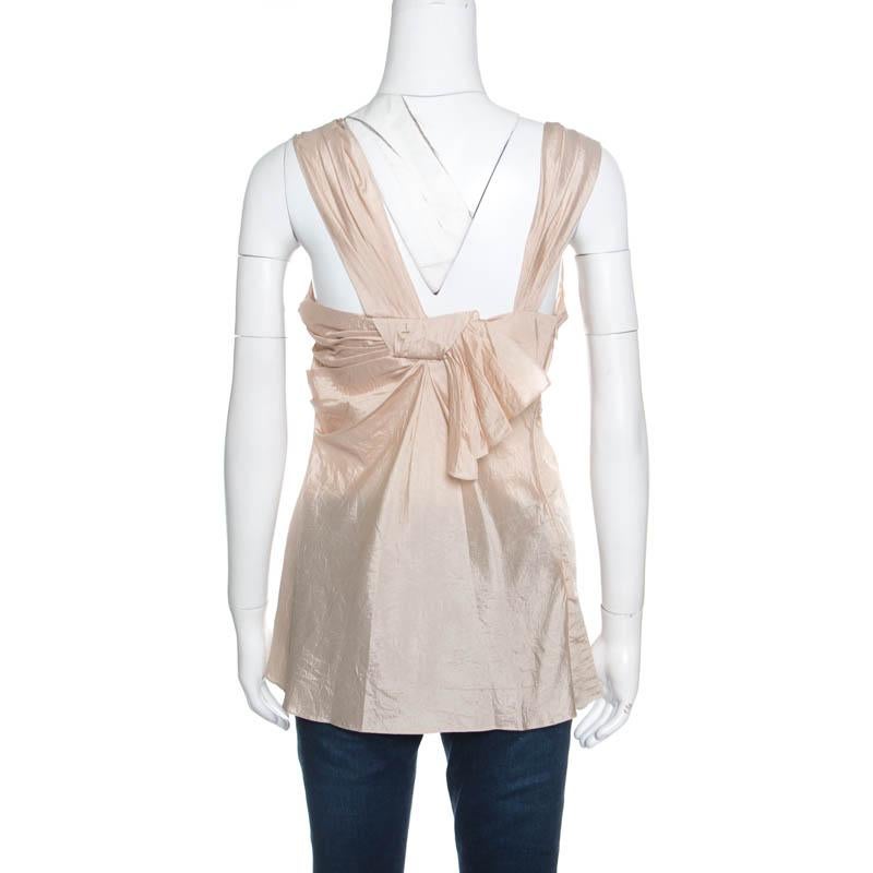 Made from Silk this Dior top deserves to be in your closet. The top features two broad straps with a sleeveless design and pleat detailing on the front and back. The beautiful beige top can be teamed up with pants and skirts.

Includes: Packaging
