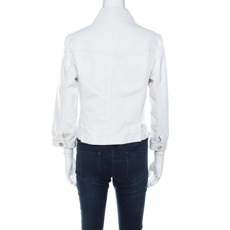There's just some magic that denim jackets bring to one's closet. They are a staple for one's casual style. Dior Boutique brings you this white jacket made from a cotton blend and designed as cropped with front button fastenings, long sleeves and