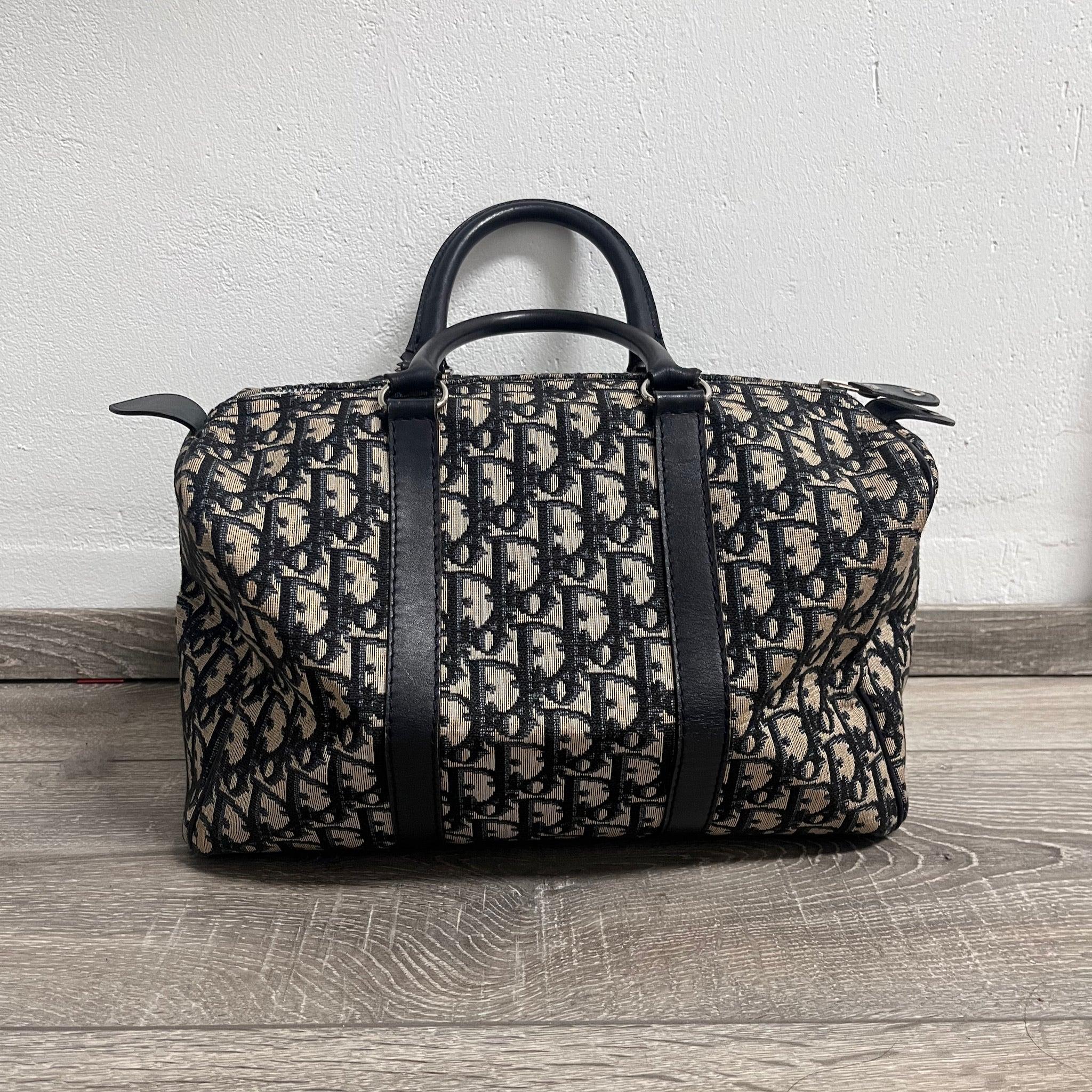 Dior Bowling Boston Bag Black Oblique Canvas
 These are professional photos of the actual bag offered by Luxbags.
 W32 x H21 x D17cm 
 Condition: Overall good to very good condition. Mould dots in the interior. Along the piping there are some scuffs