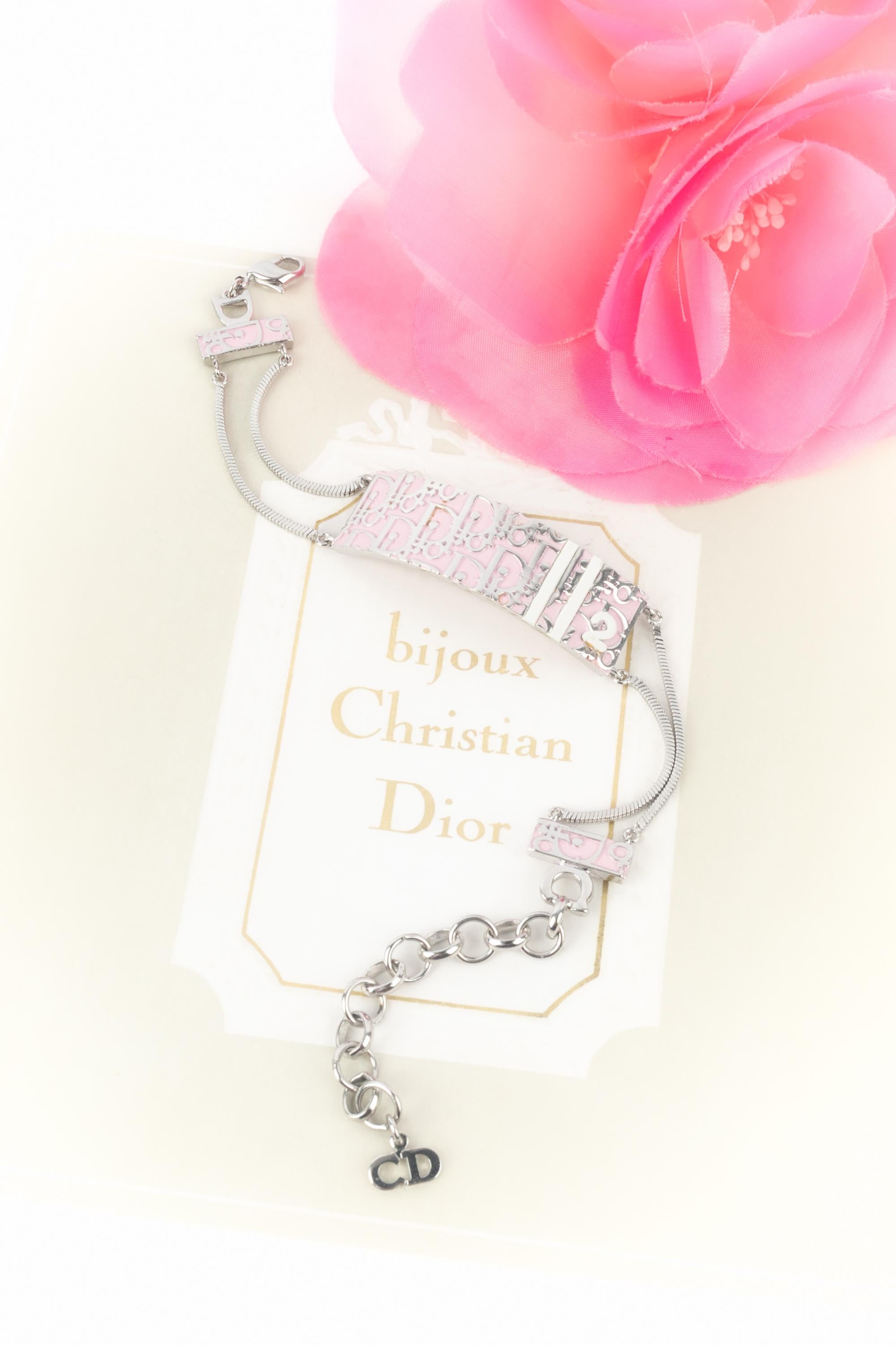DIOR - (Fabricado en Francia) Pulsera de metal plateado esmaltado en rosa y blanco. Joyas diseñadas bajo la dirección artística de John Galliano.

Estado:
Muy buen estado

Dimensiones:
Longitud: de 16 cm a 22 cm

SKU:BRA146