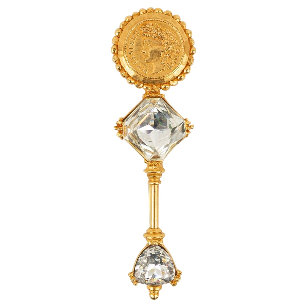 Broche Dior de metal dorado con dos grandes brillantes en venta