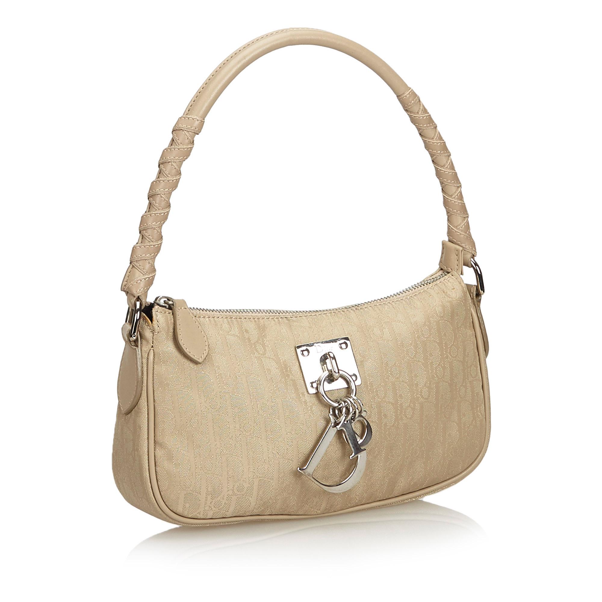 The Lovely baguette features a nylon body with leather trim, silver-tone hardware, a rolled leather handle, a top zip closure, and an interior zip pocket. It carries as B+ condition rating.

Inclusions: 
Dust Bag

Dimensions:
Length: 13.00 cm
Width: