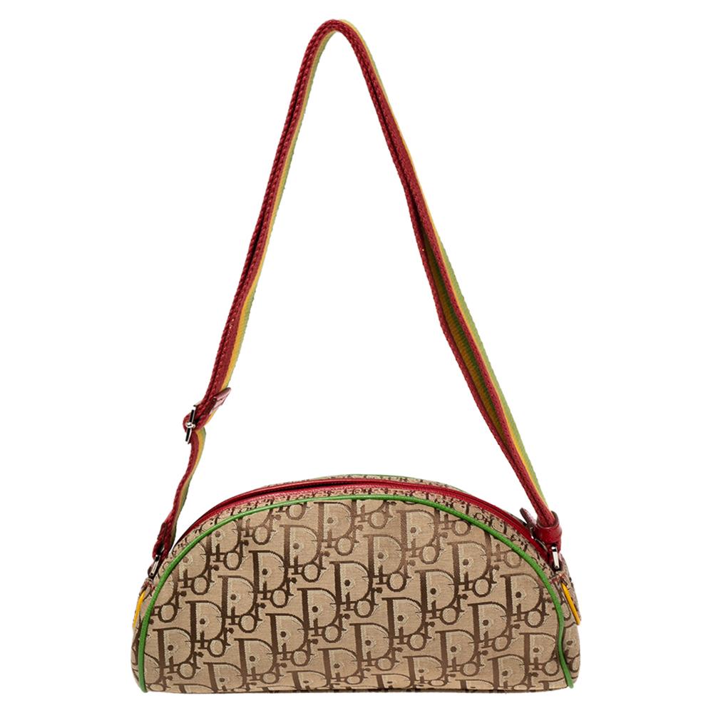 Coming from the House of Dior, this Rasta Saddle shoulder bag is a cute accessory you need to own now! It is designed using brown Diorissimo canvas, with multicolored trims elevating its beauty. It accommodates a neat fabric-lined interior and shows