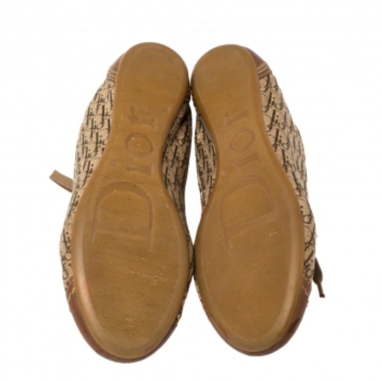 Created to provide comfort, these Dior sneakers are trendy and stylish. Meticulously crafted from Diorissimo canvas, they feature leather details, a lace-up vamp, round-toes, and rubber soles. Wear them with your casual outfits and look effortlessly