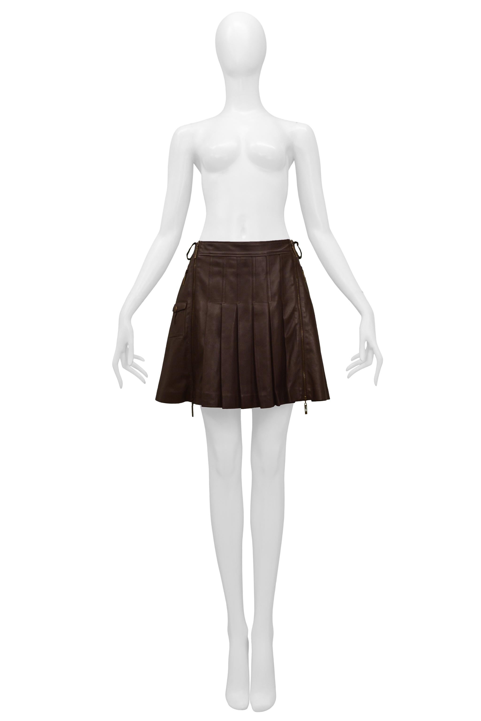 Resurrection is excited to offer a vintage Christian Dior by John Galliano, brown leather pleated mini skirt featuring two-way separating zippers at the front, patch pockets, and belt loops. 

Christian Dior
Size 38
Lambskin
Excellent Vintage