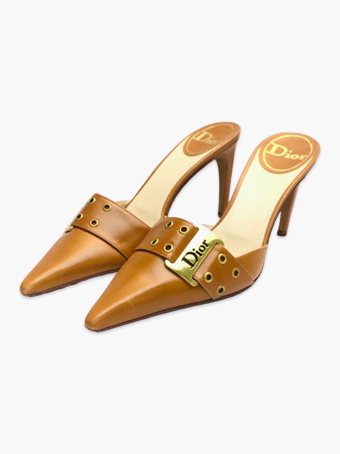 - Dior by John Galliano era brown leather slip on sandal heels in pointed toe is chic and easy to mix and match with anything from causal to formal attire.

- Rock and roll inspired metal belt details with word “DIOR” is the highlight. 

- Size 38