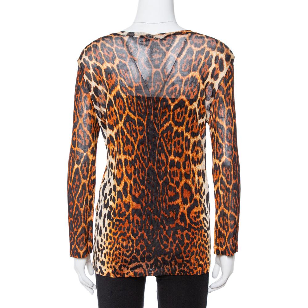 Let your closet experience a wonderful addition with this top from the house of Dior. It has been created with quality knit fabric and styled with a front pleat, round neck, and long sleeves. The brown-hued leopard print top will look amazing with