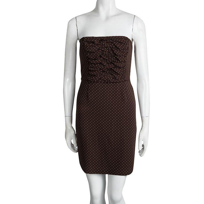 We are loving this Dior strapless dress- it's retro, girly and full of oomph. Coming from the house of Dior, this silk dress features a strapless silhouette in a brown polka dot print. It features ruching panel on the upper body and finished with a