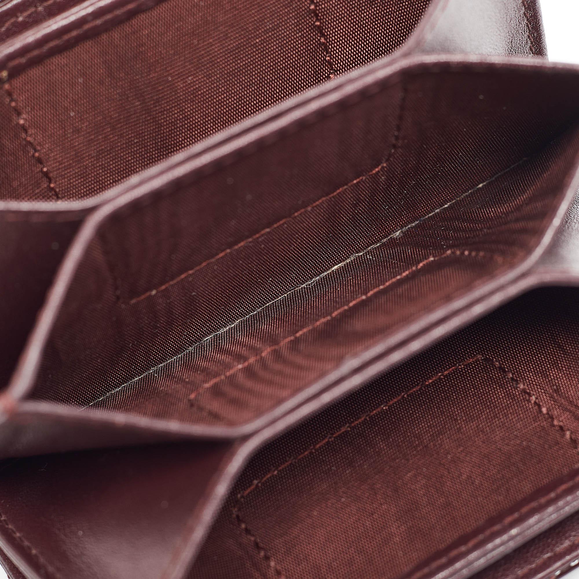 The unique silhouette of this Dior Gusset cardholder lends it a high appeal. Crafted from Cannage patent leather, it features branded charm on one side and gold-tone hardware. The leather and nylon-leather interior is divided into several