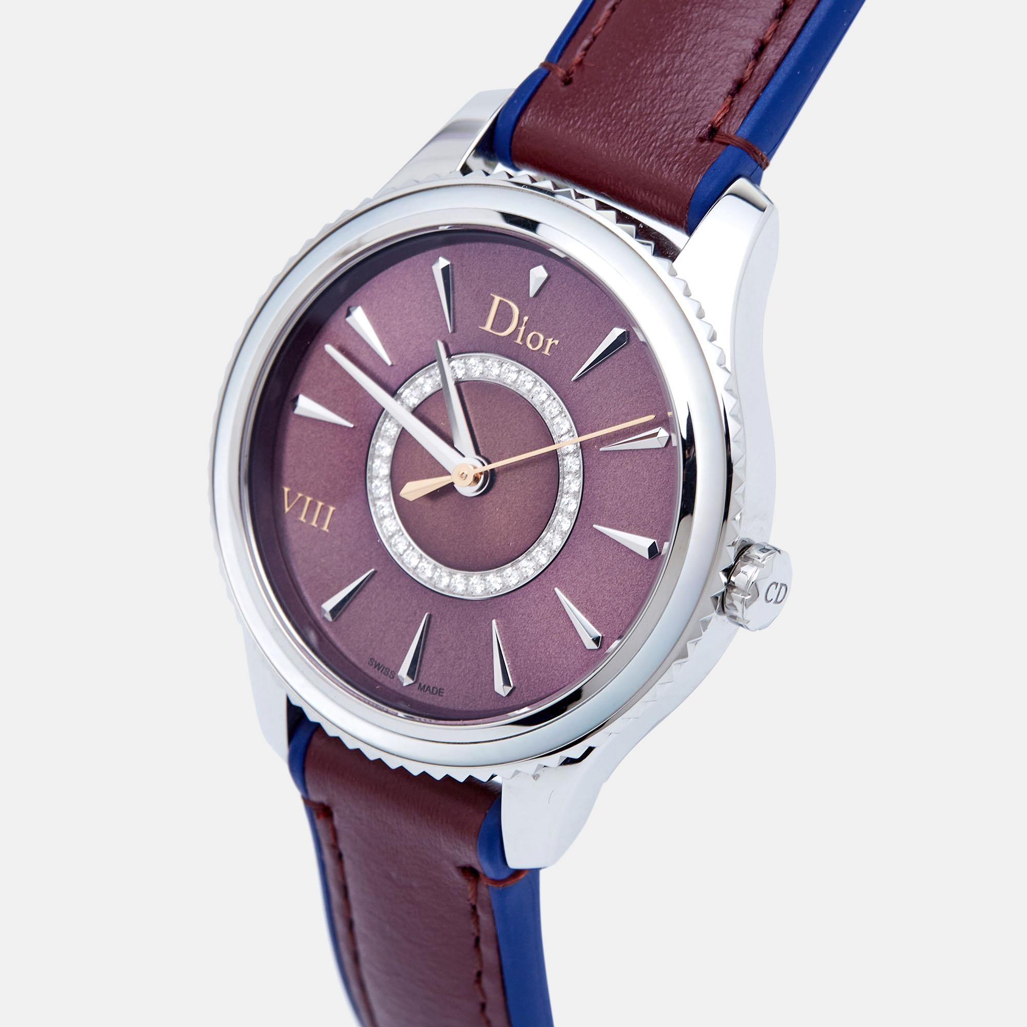 Embrace timeless luxury with the Dior wristwatch. Crafted with precision, this exquisite timepiece combines stainless steel and leather seamlessly, exuding sophistication and grace. The deep burgundy hue of the dial, adorned with shimmering