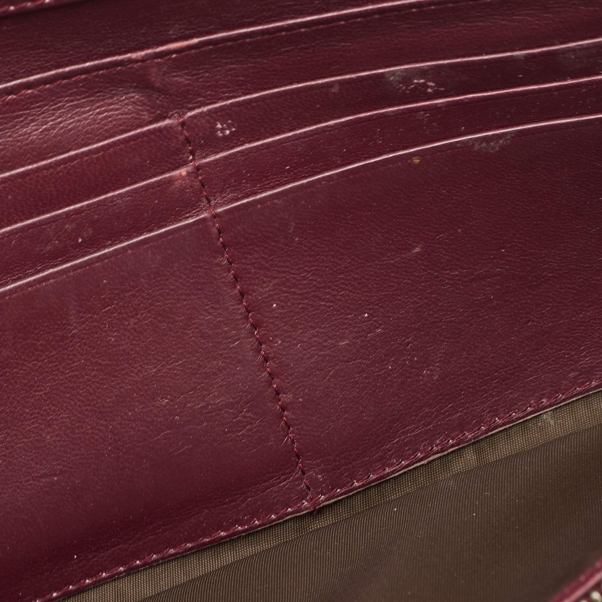 This Dior burgundy wallet is a luxurious accessory that will prove to be super functional. It is made using durable materials on the exterior and unveils a well-organized interior.