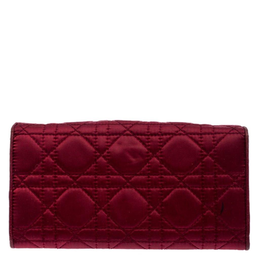 This beautifully designed Dior wallet will perfectly team up with any day or night outfit. The wallet is crafted from burgundy satin and it features Dior’s iconic Cannage quilted pattern giving the bag a beautiful texture. The exterior is finished