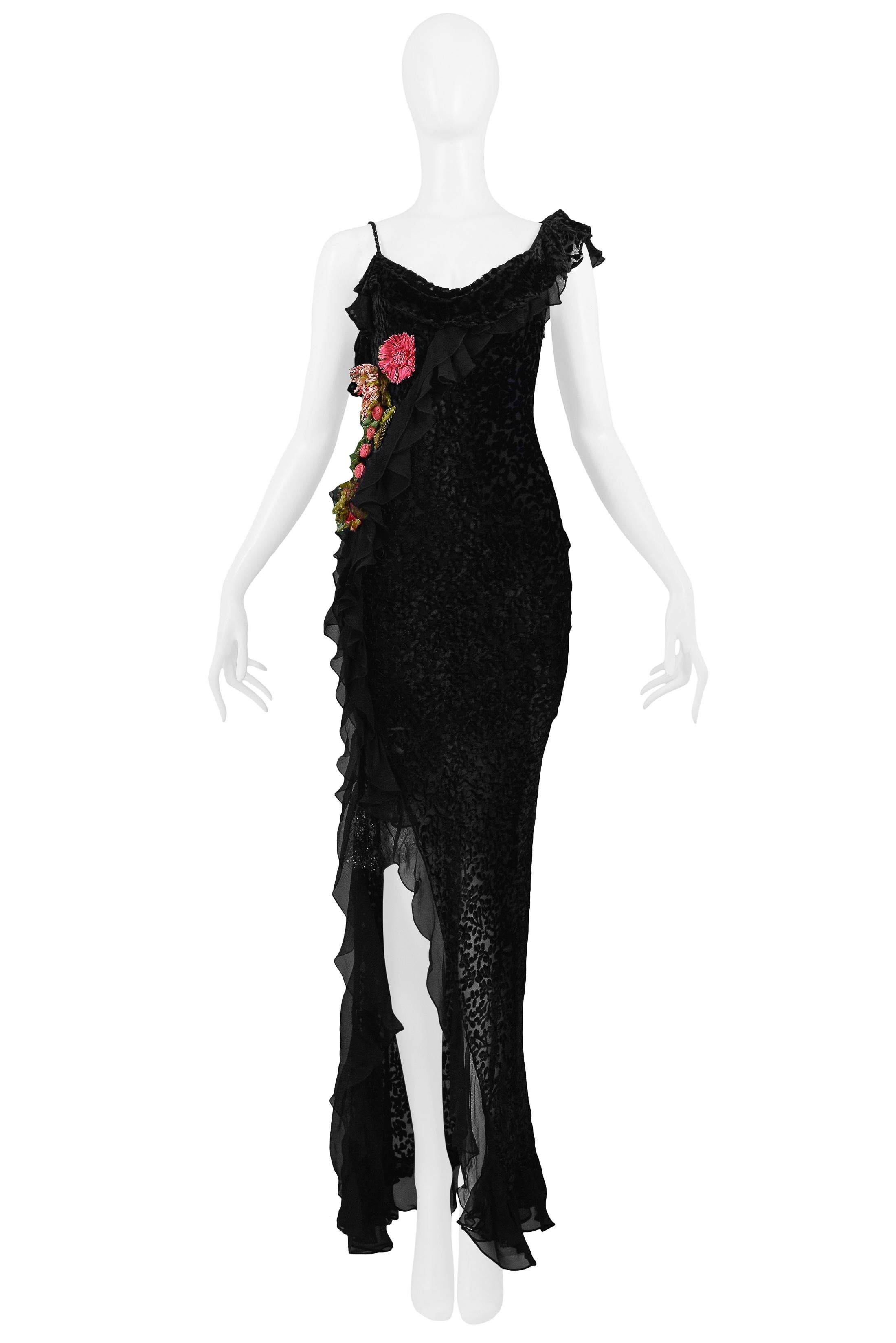 Resurrection is excited to offer this vintage Christian Dior black Devore velvet bias-cut slip dress featuring a draped neckline, spaghetti straps, pink and green raffia flowers at the waist, and asymmetrical ruffle accents at shoulder and