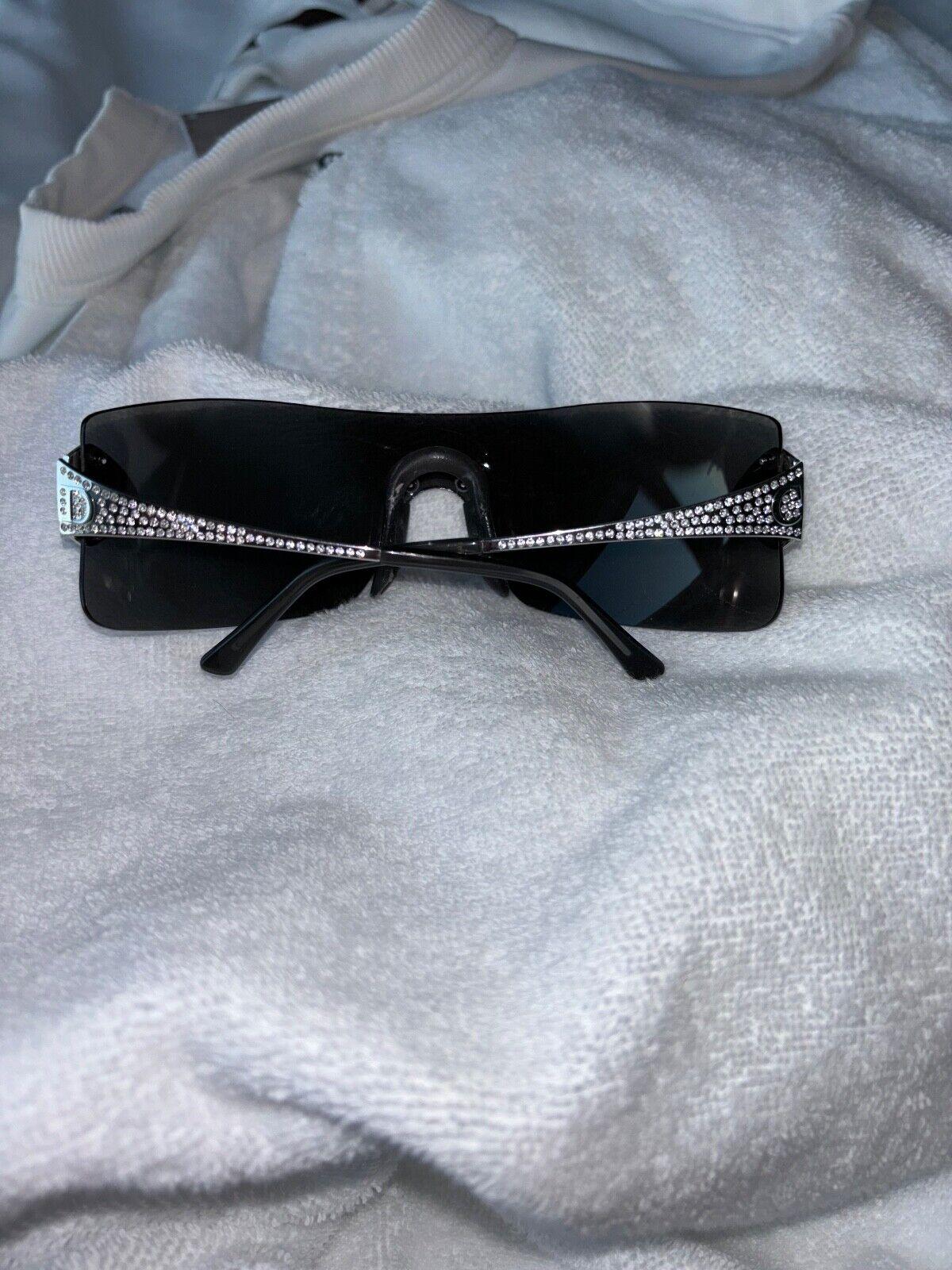 Dior by John Galliano 
Vintage
Runway
FW00
Gray lense
White Gold plated arms
Swarovski Crystals

Notes: scratches/cracked looking lens. I've worn these and from the outside you cannot see the flaws when on. Used, selling AS IS

FINAL SALE