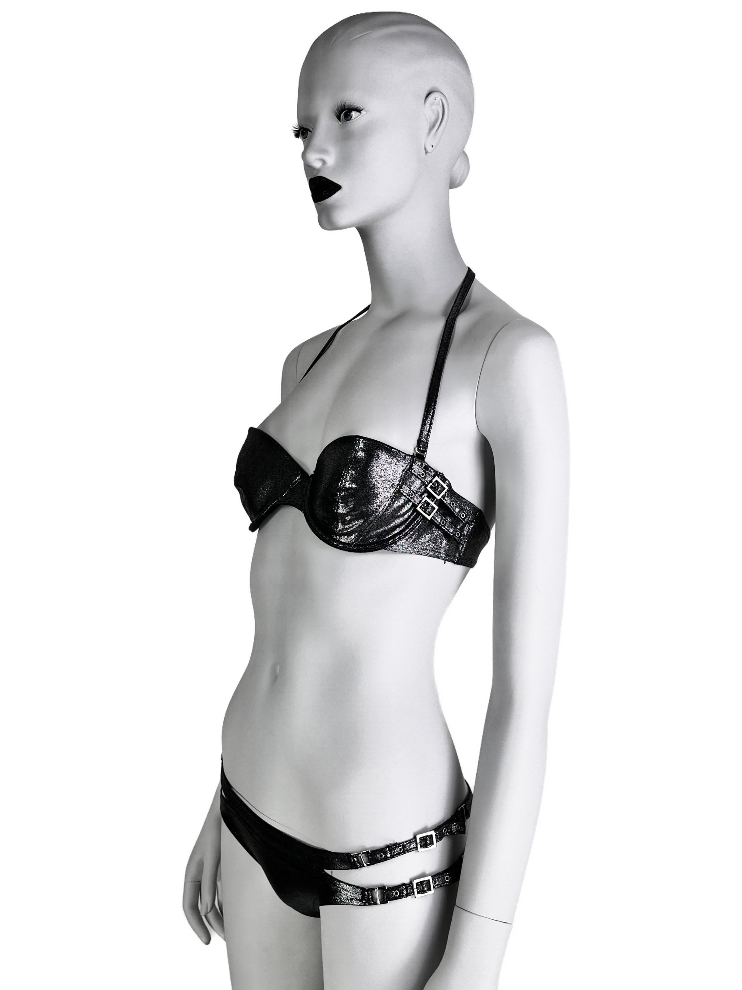 A rare Dior bikini from Spring 2004 season, similar to the ones showed on the runway in a very dark silver shade.

Featuring Dior-stamped straps and sexy cut-outs on the bottom. 

Size 34(75)B for the demi-style bikini top and FR 38 for the bottoms,