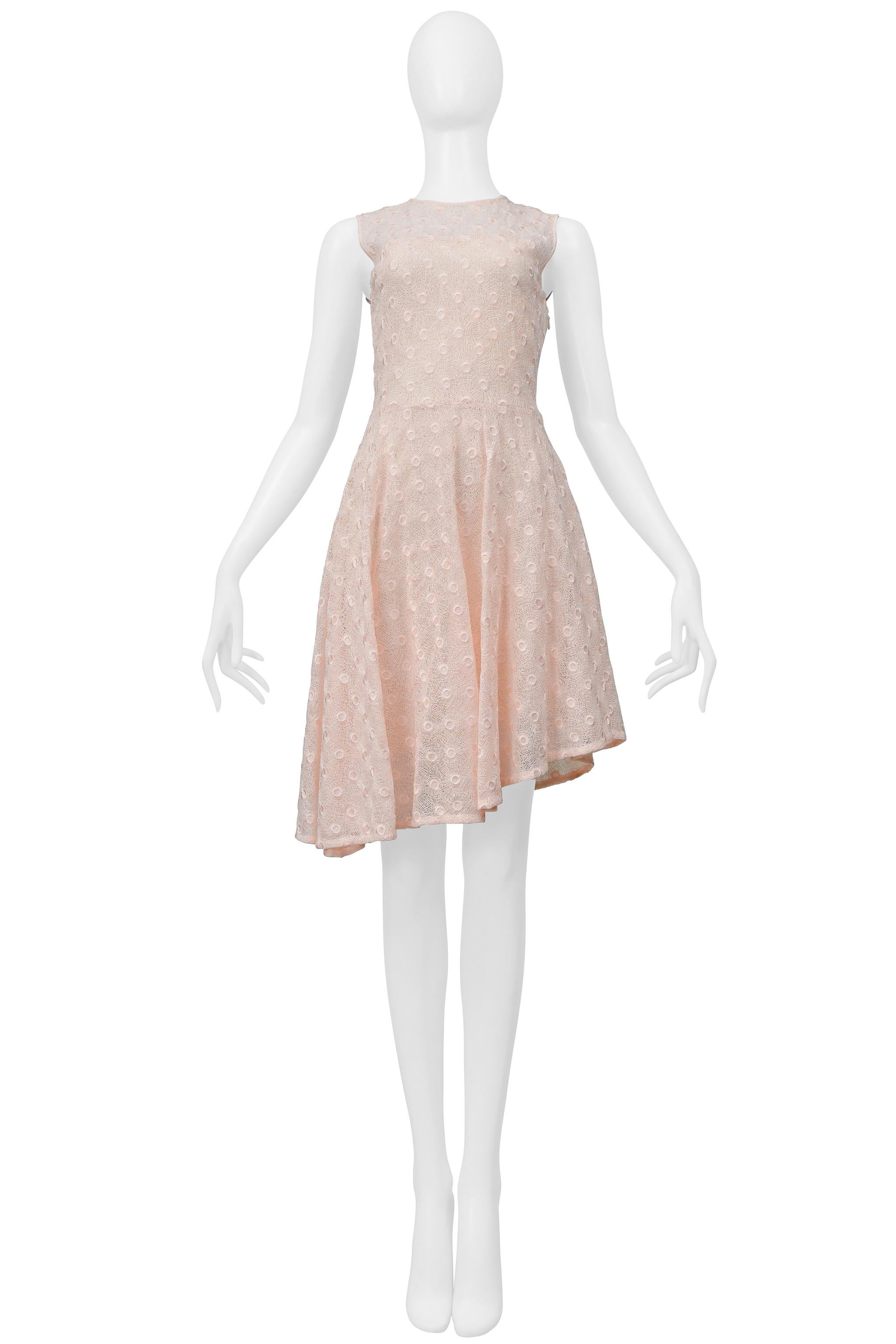 Resurrection Vintage is excited to offer a Christian Dior by Raf Simons pink lace dress, featuring delicate lace with a circular pattern, a fitted bodice, tear drop back with two buttons, a circular skirt, an asymmetrical hem, pink lining, and a
