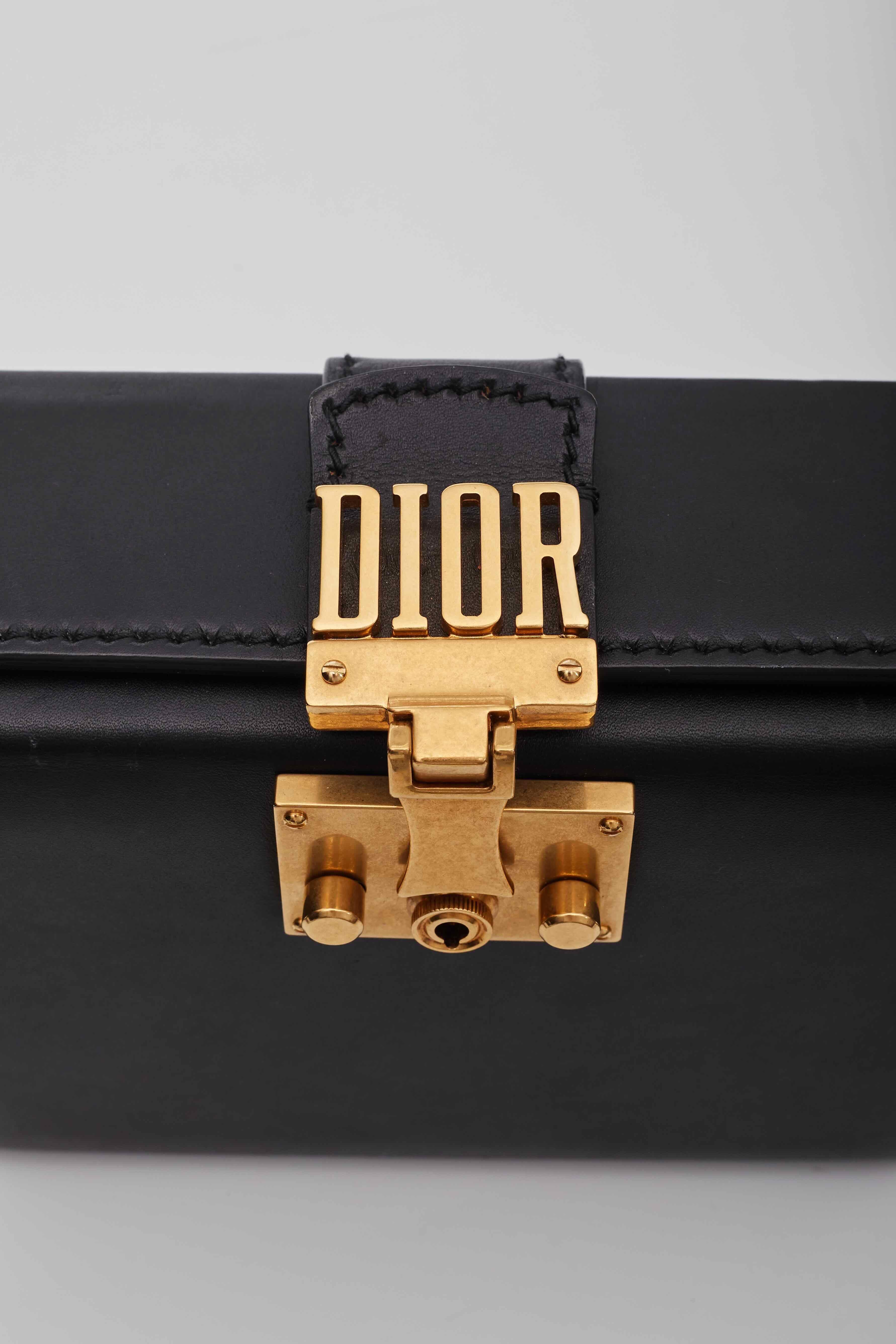 Christian Dior Shoulder Bag. From the 2017 Collection. Black Leather. Brass Hardware. Single Adjustable Shoulder Strap. Single Exterior Pocket. Suede Lining with Card Slots. Push-Lock Closure at Front.

Color: Black
Material: Leather
Measures: